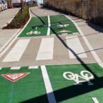 Line marking services in Sydney featuring green bicycle lanes and pedestrian crossings