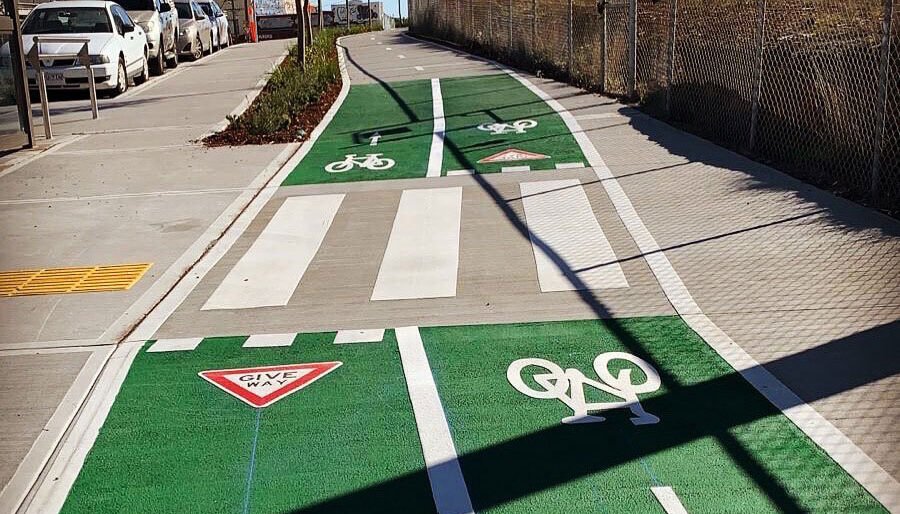 Line marking services in Sydney featuring green bicycle lanes and pedestrian crossings